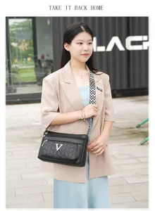 Stylish black multi-zipper shoulder bag for women with V logo and chevron quilted design.