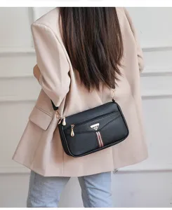 Stylish black soft leather crossbody bag for women, elegant shoulder bag with metal hardware.
