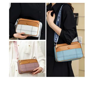 Detailed view of fashionable contrast-color crossbody shoulder bag with stylish print strap.