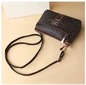Brown monogram crossbody bag for women with multiple zippers and elegant metal lock clasp.