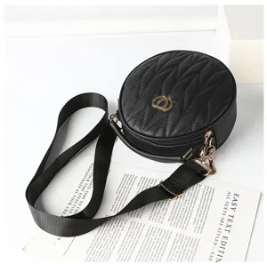 Black round quilted crossbody bag with wide strap and top handle for women daily fashion style