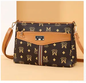 Stylish brown monogram crossbody shoulder bag with front zip pocket and metal logo plaque.
