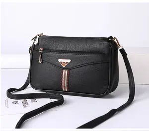 Black soft leather crossbody bag for women with metal badge and stylish vertical stripe design.