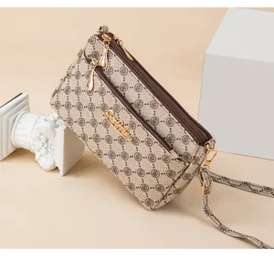Multi-layer crossbody bag for women, vintage monogram pattern shoulder handbag with straps.