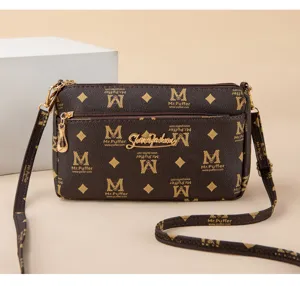 Detail view of the brown multi-layer crossbody shoulder bag with classic pattern and strap.