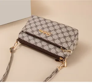 Multi-layer women's crossbody bag with stylish floral monogram pattern and gold hardware.