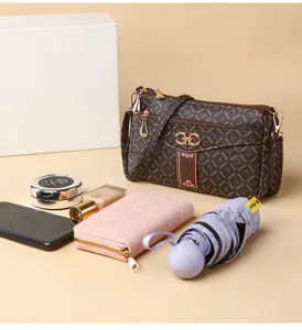 Brown monogram shoulder bag detail, elegant crossbody bag with metal lock and chic strap.