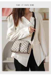 Detailed view of women vintage monogram crossbody bag with chic metallic lock and strap.