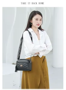 Detailed view of the stylish black quilted crossbody bag worn by model in a modern setting.
