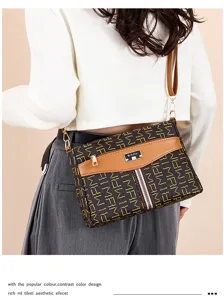 Women stylish monogram crossbody bag with flap and contrast color design for daily wear.