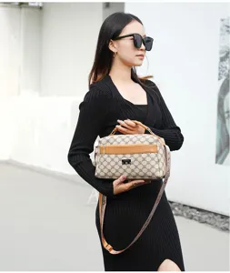 Women's crossbody shoulder bag with monogram pattern, brown leather trim, and stylish strap.