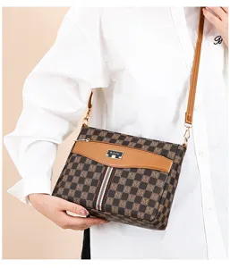Detailed view of women crossbody bag with monogram pattern, front pocket and adjustable strap.