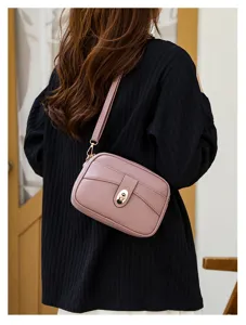 Minimalist solid color PU leather crossbody bag detail, featuring a metallic turn-lock.
