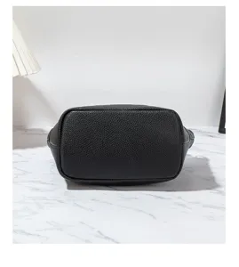 Black leather handbag bottom detail view, premium shoulder crossbody bag for women.