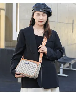 Stylish women crossbody bag with monogram pattern and brown trim, perfect for daily wear.