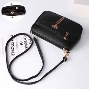 Stylish black leather crossbody shoulder bag for women with multiple compartments and strap.