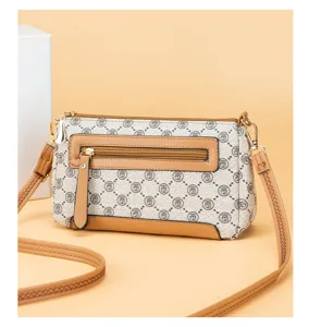Detailed view of a vintage pattern leather crossbody shoulder bag with zipper pocket.
