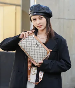 Detail view of stylish women crossbody bag, brown leather trim monogram pattern canvas.