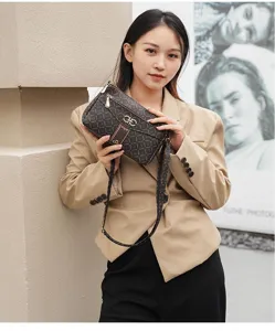 Detailed view of the stylish brown monogram crossbody bag, featuring elegant hardware and strap.
