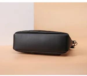 Detailed bottom and side view of a stylish black quilted women's crossbody shoulder bag.