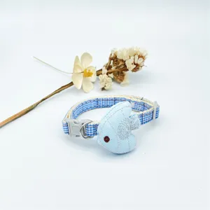 Blue and white plaid pet collar with cute fish pendant detail, soft fabric, secure buckle.