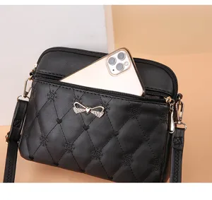 Black quilted crossbody bag for women with cute heart embroidery, stylish bow design and large capacity.