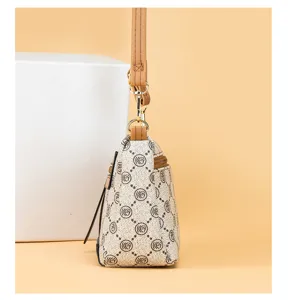 Detailed side view of the vintage monogram women leather shoulder crossbody bag with strap.