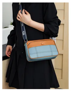 Detailed view of the stylish women's color-block crossbody shoulder bag with wide strap.