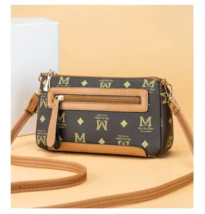 Women vintage PU leather crossbody shoulder bag with stylish monogram print and zip pockets.