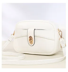 Close-up detail of the white minimalist crossbody bag, featuring a chic gold turn-lock closure.