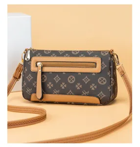 Vintage monogram crossbody bag for women with retro print, PU leather trim and gold hardware.