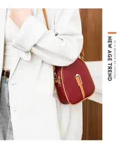 Stylish vertical crossbody phone bag for women, chic burgundy leather mini purse with gold hardware.