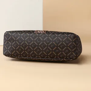 Stylish brown monogram shoulder bag for women, chic underarm purse with trendy printed pattern.