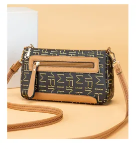 Detail view of the vintage monogram women's crossbody bag with stylish front zipper pocket.