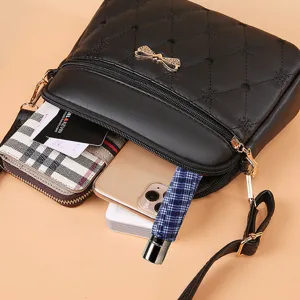 Black quilted crossbody bag for women with bow decoration and large capacity storage.