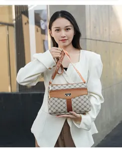 Detailed shot of the stylish women's shoulder bag with monogram pattern and strap.
