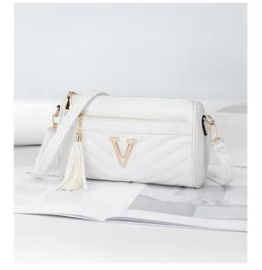 White quilted pillow shoulder bag with gold V logo and tassel detail for women fashion style.