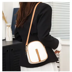 Detail view of stylish white brown vertical crossbody phone bag for women, elegant daily use.
