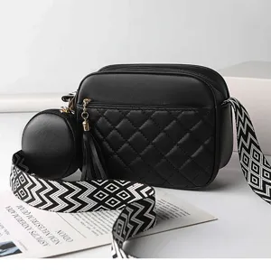Detail shot of black quilted crossbody bag with coin purse and tassel accent for women.