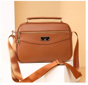 Brown PU leather small square handbag detail, crossbody strap and zipper pocket design.