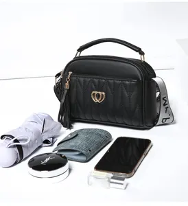 Black quilted women shoulder bag with tassel, gold heart clasp and stylish strap for daily.