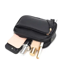 Detailed view of women's black leather crossbody bag showing large capacity and zipper details.