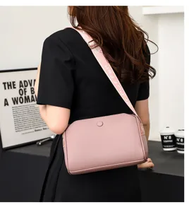 Stylish pink women crossbody bag casual shoulder bag with wide strap for daily fashion use.