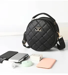 Black round quilted crossbody bag detail showing multi-layer capacity and chic design.