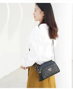 Black quilted crossbody bag for women, stylish shoulder handbag with tassel and heart lock.