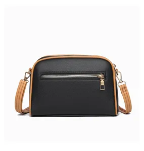 Detailed view of the women's stylish black and brown crossbody shell bag with zipper.
