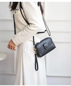 Close-up detail view of mini fashion black crossbody phone bag with strap for women.