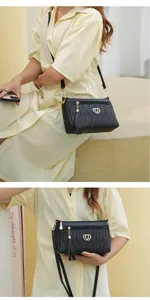 Black quilted women crossbody bag with tassel and heart charm, multi-compartment detail view.
