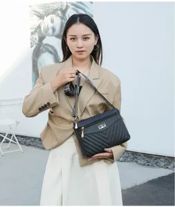 Women's stylish black quilted shoulder bag with wide strap, trendy casual crossbody design.