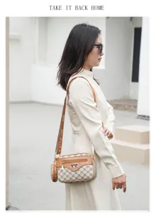 Classic monogram shoulder bag for women, stylish crossbody bag with wide strap detail.